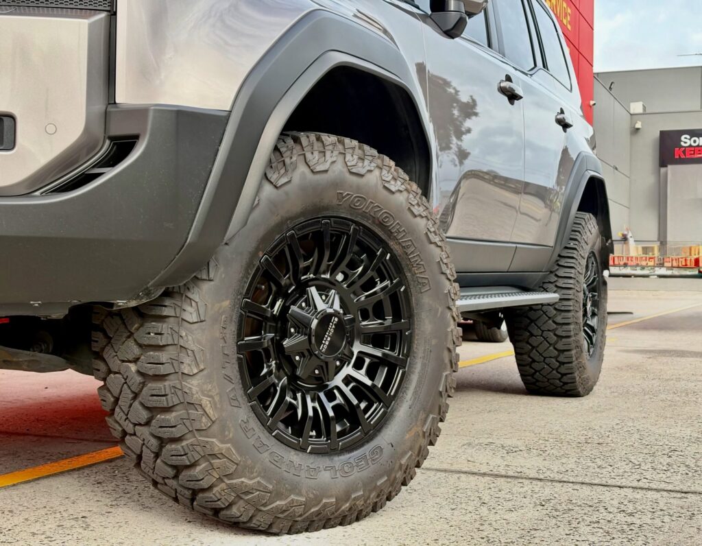 Black alloy wheel and Yokohama Geolandar tyre on a silver 4WD at Tyreforce.