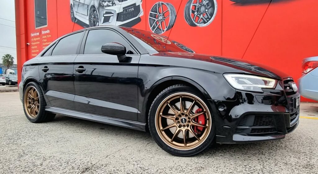 Black Audi RS3 sedan fitted with JSR ST37 bronze alloy wheels outside Tyreforce.