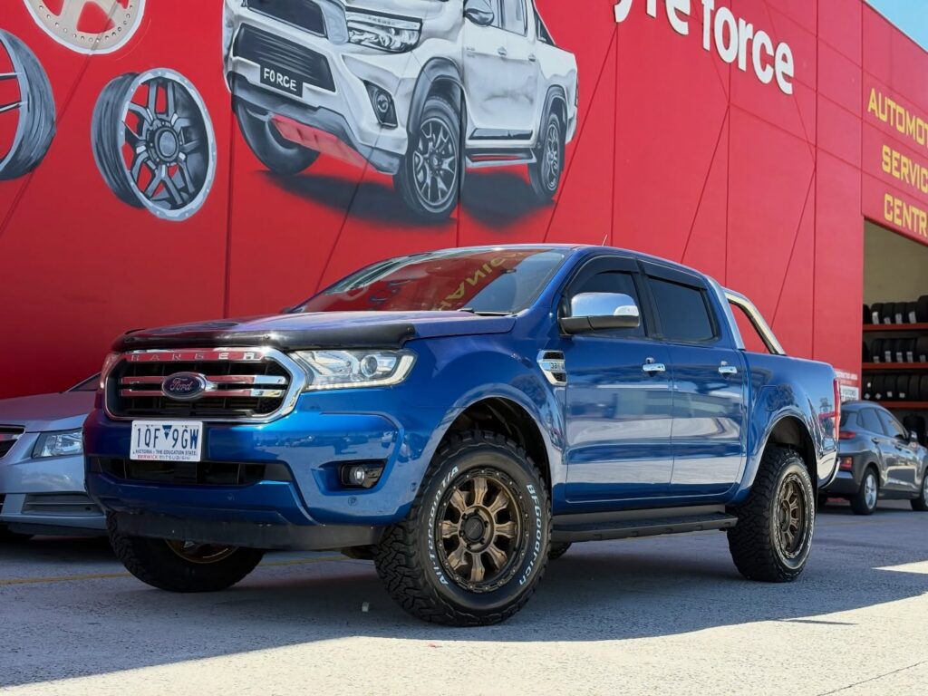 Blue Ford Ranger with bronze alloy wheels and BFGoodrich all-terrain tyres outside Tyreforce.