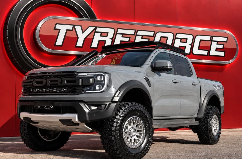 Grey Ford Ranger Raptor with silver alloy wheels and off-road tyres.