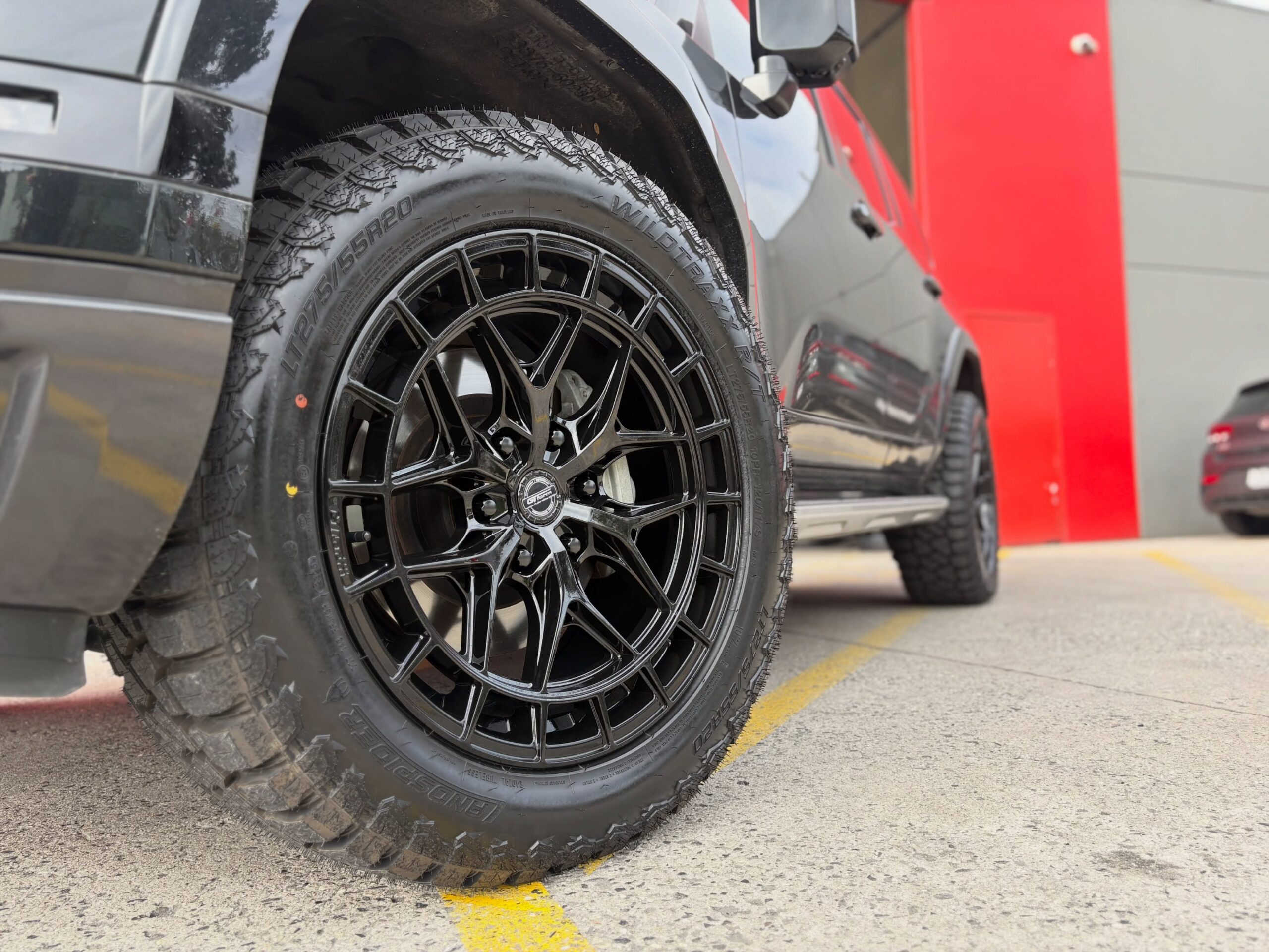 Close-up of a black multi-spoke alloy wheel and all-terrain tyre fitted to a Lexus GX at Tyreforce.