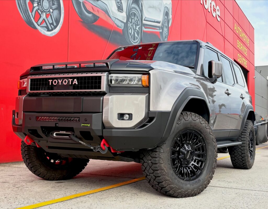 Silver Toyota Prado 250 with black alloy wheels and off-road tyres outside Tyreforce.
